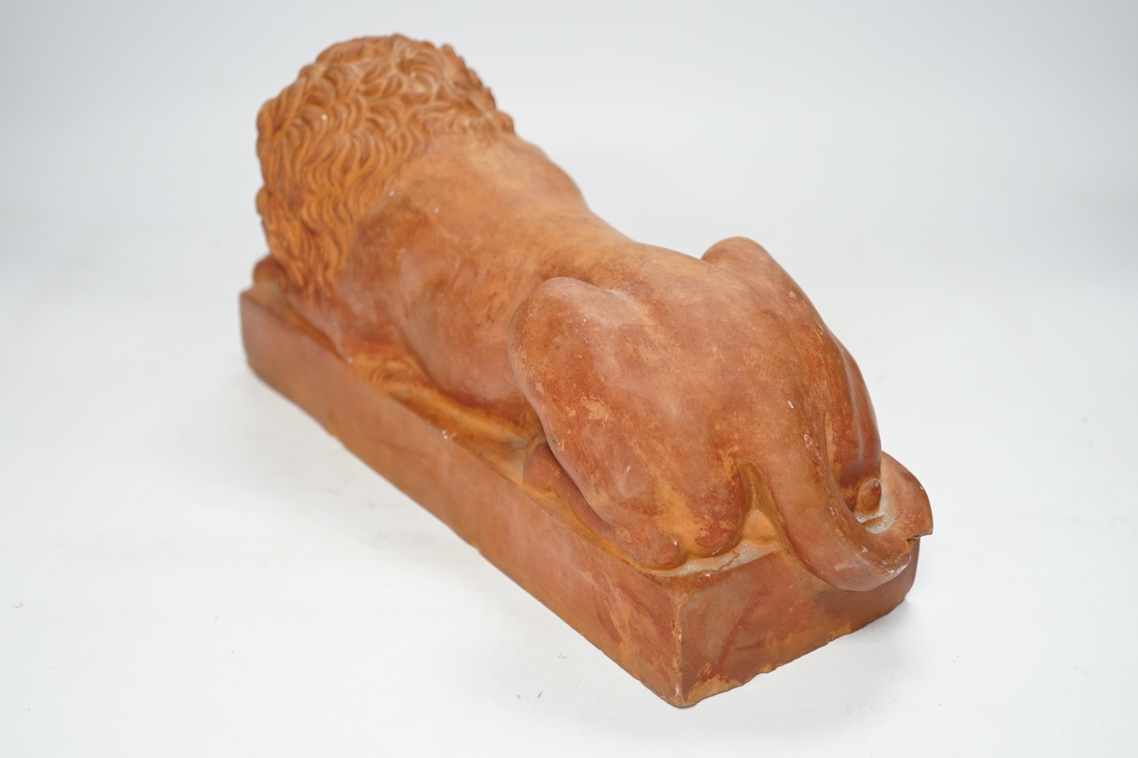 After Antonio Canova (1757-1822), a terracotta figure of a recumbent lion, 33cm. Condition - poor to fair